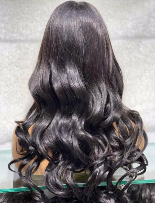 Back view of the long brown wavy human hair wig displaying natural movement, fullness, and wave definition.