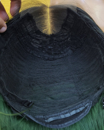 Close-up of the pre-plucked hairline on a short dark green lace front wig.