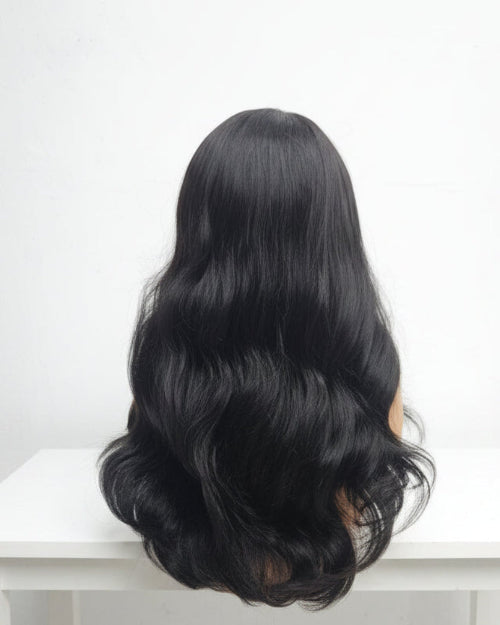 Close-up view of the texture on a Body Wave Wig with Bangs. Natural movement.
